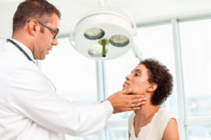 Arts controleert de schildklier van een vrouw 